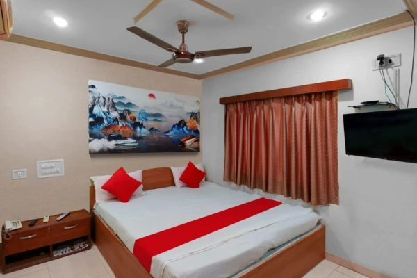 Hotel room with double bed and wall TV
